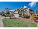 Beautiful home with mature landscaping and a well-kept lawn at 9716 Pecky Cypress Way, Orlando, FL 32836