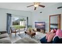 Bright living room featuring a sliding glass door, neutral paint, and tile flooring at 9836 Dean Cove Ln, Orlando, FL 32825