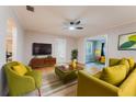 Cozy living room showcasing hardwood floors, comfortable seating and a ceiling fan at 1032 W 2Nd St, Sanford, FL 32771