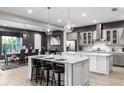 Spacious kitchen with gray cabinets, white island, and stainless steel appliances at 1039 Jack Nicklaus Ct, Kissimmee, FL 34747