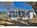 Charming screened-in porch with wood steps, offering a relaxing outdoor space at 105 N Ortman Dr, Orlando, FL 32805