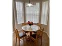 Cozy breakfast nook with a round table and four chairs, perfect for enjoying morning meals at 1128 S Beach Cir, Kissimmee, FL 34746