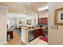 Open-concept kitchen featuring granite countertops, wood cabinets, and stainless steel appliances at 1375 Tuscana Ln # 1107, Davenport, FL 33896