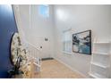 Bright foyer with white walls, hardwood floors, and a staircase at 1505 Mumbai Way, Kissimmee, FL 34747