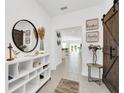 Bright entryway with a stylish console table and large mirror at 157 Pineywoods St, St Cloud, FL 34769