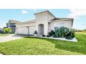 Two-story home with a two-car garage and landscaped front yard at 157 Pineywoods St, St Cloud, FL 34769