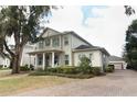 Charming home featuring a brick driveway, mature landscaping, and a welcoming front porch at 179 Hillcrest Dr, Oviedo, FL 32765