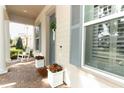 Inviting front porch featuring rocking chairs, stylish planters, and a charming welcome mat at 179 Hillcrest Dr, Oviedo, FL 32765