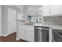 Modern kitchen with white cabinets, stainless steel appliances, and a breakfast bar at 202 E South St # 1048, Orlando, FL 32801