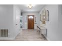Bright entryway with wood flooring, a console table, and wood door at 2031 Eaton St, Maitland, FL 32751
