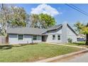 Ranch style home with gray siding, mature trees, and a spacious yard at 2031 Eaton St, Maitland, FL 32751