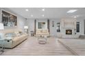Spacious living room with light flooring, a fireplace, and comfy furniture at 2031 Eaton St, Maitland, FL 32751