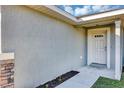 Close-up of the front entrance featuring a stone column and a light green door at 21 Juniper Loop Cir, Ocala, FL 34480