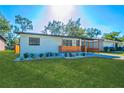 Newly renovated home with a modern exterior and well-manicured lawn at 2414 Herbison Dr, Orlando, FL 32810