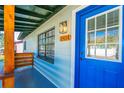 Charming blue front door with a white frame and wood accents at 2414 Herbison Dr, Orlando, FL 32810