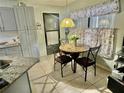 Cozy kitchen with granite counters and gray cabinets at 247 Cranbrook Dr, Kissimmee, FL 34758