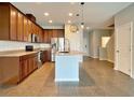 Open concept kitchen with island and stainless steel appliances at 2646 River Landing Dr, Sanford, FL 32771