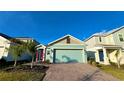 Inviting single-Gathering home showcasing a large two-car garage and a lovely aqua exterior at 2713 Runners Cir, Clermont, FL 34714