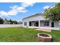 Large, green backyard featuring a screened in porch and white picket fence at 2717 Treymore Dr, Orlando, FL 32825