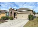 Charming single-story home with a well-manicured lawn, two car garage, and a stone-accented entryway at 2931 Top Water Way, Kissimmee, FL 34746