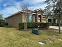 Well-maintained yard and lawn of single Gathering house, with beautiful green shutters and stone entryway at 2931 Top Water Way, Kissimmee, FL 34746