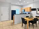 Kitchen with light wood cabinets, black appliances, and granite countertops at 3002 Red Ginger Rd, Kissimmee, FL 34747