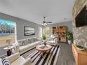 Bright living room featuring a comfy sofa, wood-look floors, and a modern fireplace at 3124 Oak Brook Ln, Eustis, FL 32736