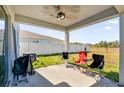 A covered patio with a ceiling fan and outdoor seating offers a relaxing outdoor space at 361 Preserve Pointe Blvd, Davenport, FL 33837