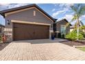 Beautiful single story home with manicured landscaping, a brick driveway and a two car garage at 508 Zamora Way, Davenport, FL 33837