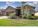 Beautiful single story home with manicured landscaping, a brick driveway and a two car garage at 508 Zamora Way, Davenport, FL 33837