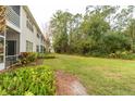 Spacious backyard with lush greenery and a grassy area at 5999 Lake Pointe # 609, Orlando, FL 32822