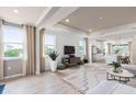 Open living space with hardwood floors and a view of the kitchen at 7345 Ivy Tendril Ave, Orlando, FL 32829