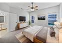 Bright bedroom with king-size bed, ensuite bathroom access, and pool view at 812 Lockbreeze Dr, Davenport, FL 33897