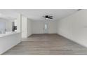 Bright living room with wood-look flooring and access to kitchen at 1021 Flagler Ave, Edgewater, FL 32132