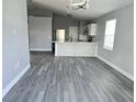 Open-concept living and dining room with hardwood floors and natural light at 1057 Inkberry Ct, Orlando, FL 32811