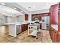 Spacious kitchen featuring stainless steel appliances, central island, and rich cabinetry at 1331 Common Way Rd, Orlando, FL 32814