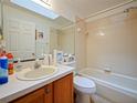 Well-lit bathroom featuring a vanity, a toilet, and a shower-tub combination at 1614 Stanbury Dr, Orlando, FL 32818