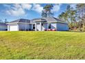 View of the home's exterior showing the home sitting on a beautiful green lawn at 17008 Sw 32Nd Ter, Ocala, FL 34473