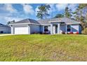 Charming single-story home featuring a well-manicured lawn and an attached two-car garage at 17008 Sw 32Nd Ter, Ocala, FL 34473