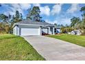 Charming single-story home featuring a well-manicured lawn, driveway, and attached garage at 17008 Sw 32Nd Ter, Ocala, FL 34473