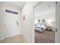 Entryway with white door and view into a bedroom with gray bedding at 175 Claffey Ct, Haines City, FL 33844