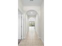 Bright hallway with arched doorways and tile floors at 175 Claffey Ct, Haines City, FL 33844