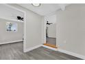 Bright hallway with gray flooring and access to other rooms at 204 Louis St, Leesburg, FL 34748