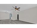 Spacious living room with gray flooring and ceiling fan at 204 Louis St, Leesburg, FL 34748