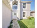 Inviting front entrance showcasing a decorative glass door and well-kept landscaping at 2120 Marisol Loop, Kissimmee, FL 34743