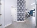 Entryway boasts gray floors with a patterned pillar and opens to main living area at 2551 Bear Creek Ct, Kissimmee, FL 34747