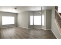 Bright dining room with bay window, wood-look flooring, and neutral walls at 2586 Grand Central Pkwy # 1, Orlando, FL 32839