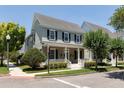 Two-story house with gray siding, black shutters, and a teal front door at 4006 Markham Pl, Orlando, FL 32814
