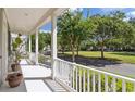 White porch with white railings overlooking a grassy park-like area at 4006 Markham Pl, Orlando, FL 32814