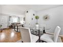 Open-concept dining area with hardwood floors and modern glass table at 783 Cornelia Ct, Orlando, FL 32811